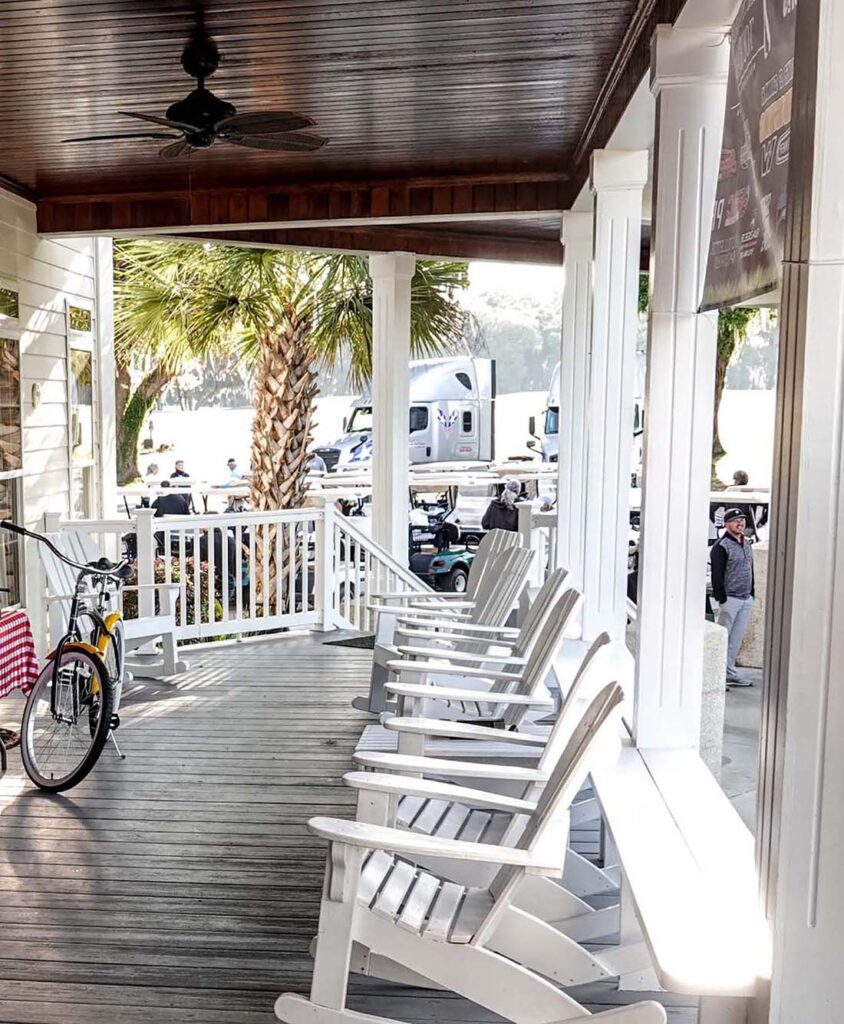 Porch with rocking chairs and bicycle outside.